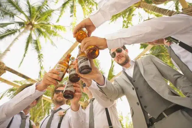 A Group Of Men Toasting Beer