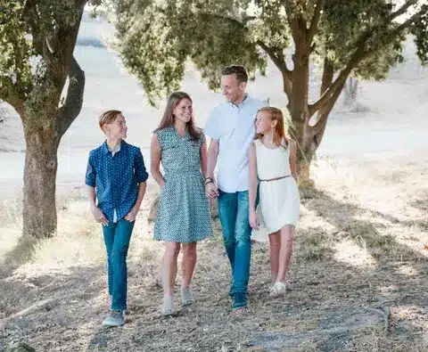 A Happy Family Walking Past by the Park