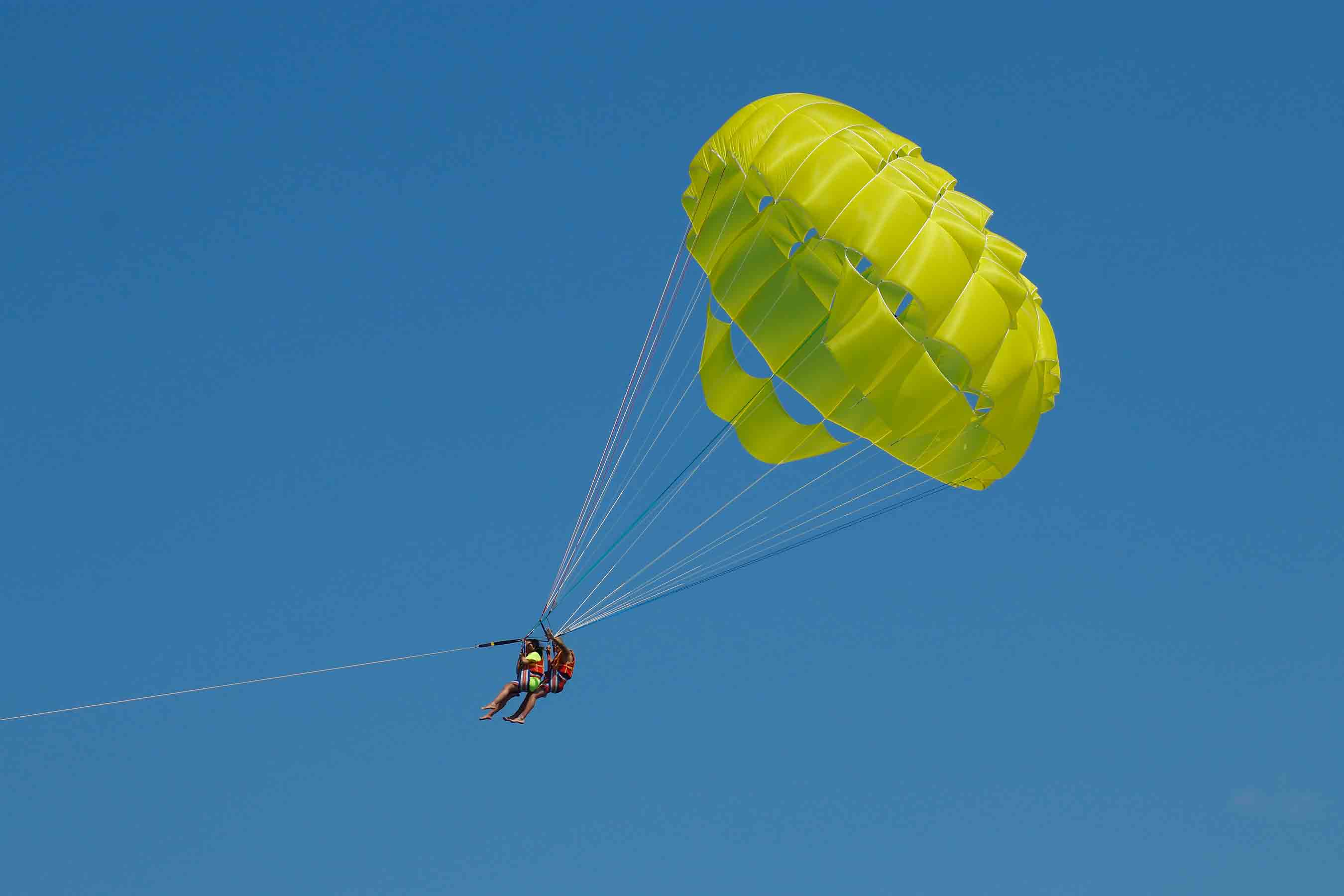 Two Person Doing A Parasailing Activity
